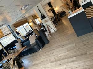 an overhead view of a living room with wood floors at Hotel De La Mer in Le Barcarès