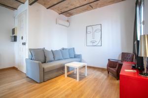 a living room with a blue couch and a table at 51no1058 - Bright 1bed flat in Poble Sec in Barcelona