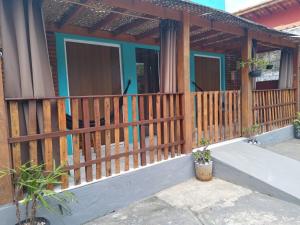 a house with a wooden fence and a porch at Chale proximo a praia in Ilhabela