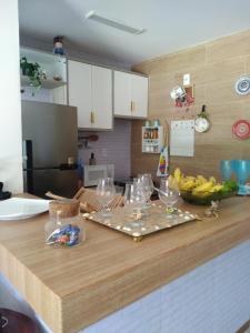 a kitchen with a counter with glasses and bananas on it at Village Solaris in Imbassai