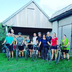 a group of people posing for a picture with their bikes at Ismayilli Guest House in İsmayıllı