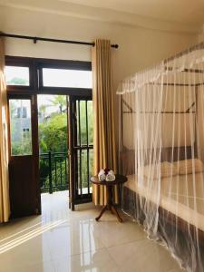 a room with a table and a large window at Samaro Resort in Matara