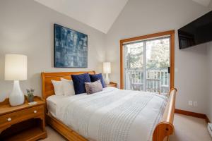 a bedroom with a large bed and a window at 2BR Very Spacious Townhome in a Great Location by Harmony Whistler in Whistler