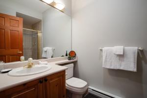 a bathroom with a sink and a toilet and a mirror at 2BR Very Spacious Townhome in a Great Location by Harmony Whistler in Whistler +22 photos