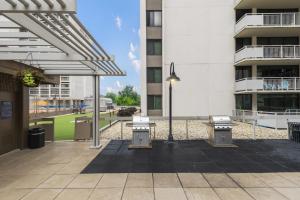 a courtyard with three benches and a building at Enjoy your stay at this condo in Crystal City in Arlington