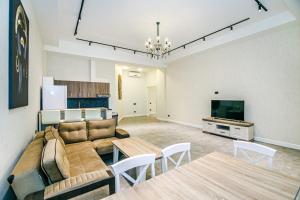 a living room with a couch and a table at Two-Bedroom Apartment City Center in Baku