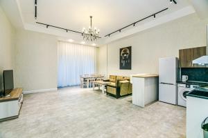 a living room with a kitchen and a dining room at Two-Bedroom Apartment City Center in Baku