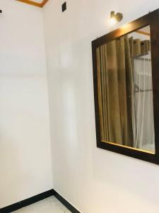 a mirror on a wall in a room at Samaro Resort in Matara