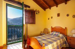 - une chambre avec un lit et un balcon avec vue dans l'établissement Casa BegoñaSituada en Sardedo Ribadesella, à Linares