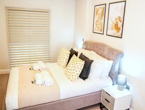 a bedroom with a bed with pillows on it at Shrewsbury apartments by BEVOLVE - Free Parking in Shrewsbury