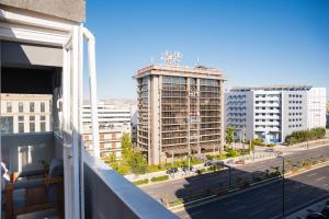 a view of a city from a balcony at 3C’s Athens South @Delta: SNFCC / Faliro Seaview Penthouse in Athens