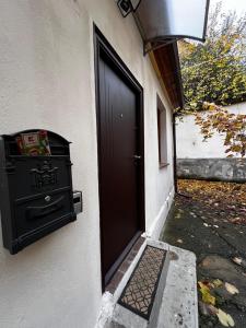 a black door to a house with a stove at Eden Garden in Braşov