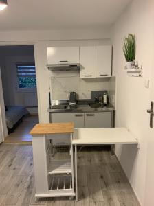 a small kitchen with a counter and a table at Apartament pod Zamkiem Chojnik in Jelenia Góra