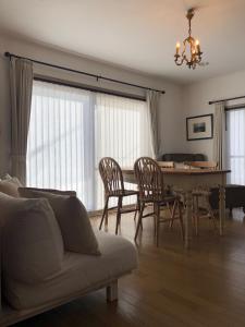 a living room with a dining room table and chairs at Cachtte Nagisa - Vacation STAY 95387v in Zushi