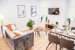 a living room with a couch and a table at Shrewsbury apartments by BEVOLVE - Free Parking in Shrewsbury