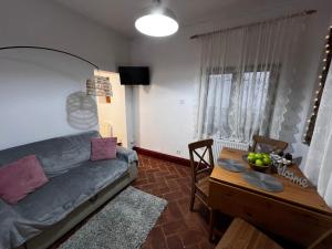 a living room with a couch and a table at Eden Garden in Braşov