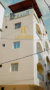 a building with a sign on the side of it at LOCABISS in Rufisque