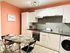 a kitchen with a table with chairs and a sink at Luxury Flat at Temple Bar Dublin in Dublin