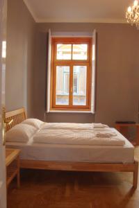 a bed in a room with a window at Market Square Apartment II. in Budapest