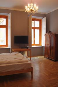 a bedroom with a bed and a flat screen tv at Market Square Apartment II. in Budapest