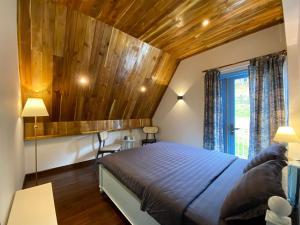 a bedroom with a bed and a wooden ceiling at Triền Thông An Nhiên Đà Lạt Rừng Trong Phố in Da Lat