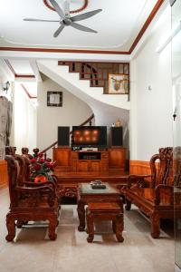 a living room filled with furniture and a tv at Tom's house motorbikes tour and homestay in Làng Me