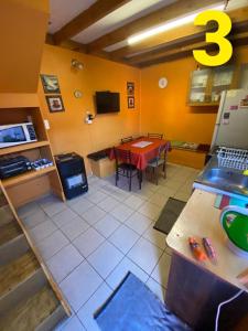a room with a table and a kitchen with a tableablish at Departamentos Puerto Montt in Puerto Montt