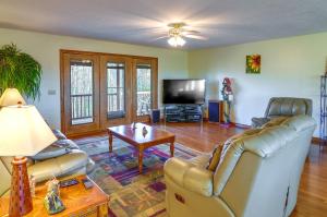 a living room with a couch and a tv at Byrdstown Apartment Less Than 4 Mi to Dale Hollow Lake! in Frogue
