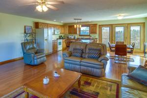 a living room with couches and a table and a kitchen at Byrdstown Apartment Less Than 4 Mi to Dale Hollow Lake! in Frogue