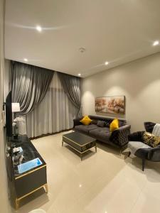 a living room with a couch and a table at The Beach House in Muscat