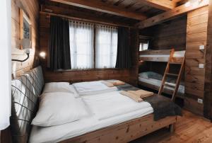 a bedroom with a bed in a wooden cabin at Mei Zeit Hüttendorf in Turracher Hohe +287 photos