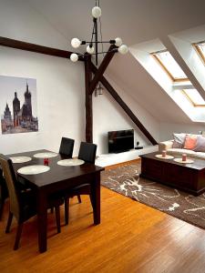 sala de estar con mesa y sofá en Apartamenty Długa 27, en Cracovia