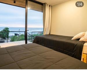 Postel nebo postele na pokoji v ubytování Cabañas Pacífico Matanzas Completa