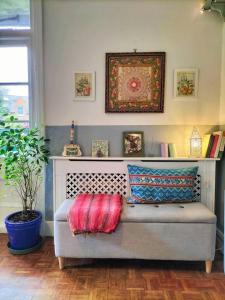 a couch with pillows on it in a room at Highgate apartment with balcony in London