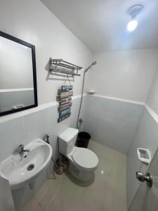 a bathroom with a white toilet and a sink at Marilao Staycation near Philippine Arena Bulacan with FREE PARKING by Retro354 Condotel in Marilao
