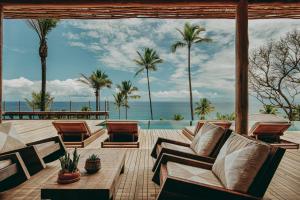 a living room with a view of the ocean at Barracuda Hotel & Villas in Itacaré
