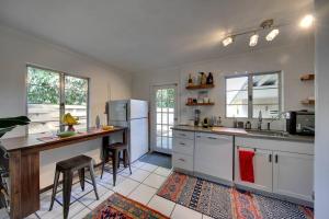 a kitchen with a refrigerator and a table in it at Charming old Florida home 15 mins from beaches in Sarasota
