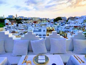 a table with a plate of food on top of a city at Dar Nour in Tangier