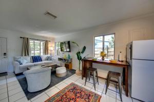 a kitchen and living room with a white refrigerator at Charming old Florida home 15 mins from beaches in Sarasota