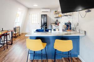 a kitchen with a blue island with two yellow bar stools at The Haven in Hot Springs