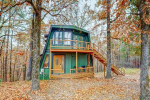 a green tiny house with a staircase in the woods at The Haven in Hot Springs