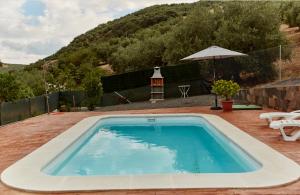 - une piscine dans une cour avec une montagne dans l'établissement Casa Mártires, à Iznájar
