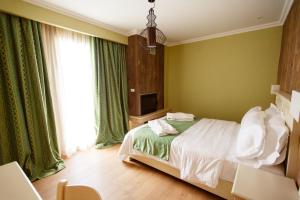 A bed or beds in a room at Irene's Resort