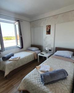 a bedroom with two beds and a window at Gas Otel in Belgrade