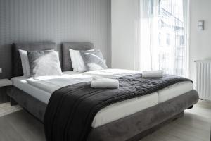 Posteľ alebo postele v izbe v ubytovaní Harmony Apartments Sárvár