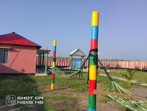 a group of colorful poles with a playground at Coral lagoon resort in Jaliapāra