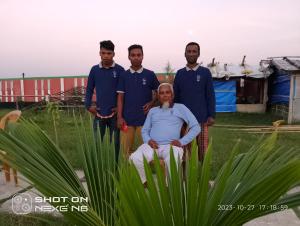 a group of people standing around a plant at Coral lagoon resort in Jaliapāra