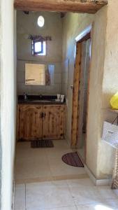 a kitchen with wooden cabinets in a room at Siwa desert home in Siwa