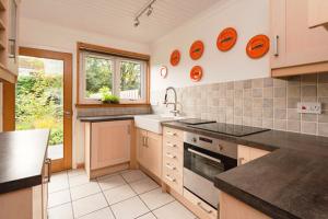 a kitchen with orange plates on the wall at Shamerbrea Design Townhouse in Inverness