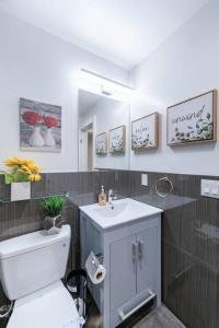 a bathroom with a white toilet and a sink at 20 Guest Oasis - Spacious SF Skyline Getaway! in San Francisco